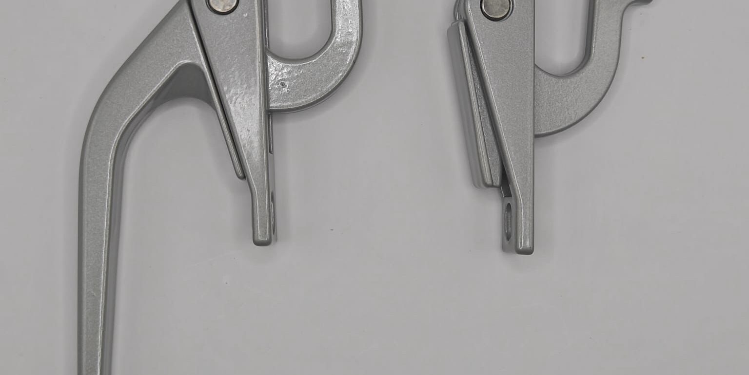 Close-up of aluminium window handle in zinc alloy powder coating. Manufactured according to BS 1004-1972 Alloy A standard, surface 400°C high-temperature baked. Suitable for Hong Kong aluminium window repairs and mandatory window inspection projects.