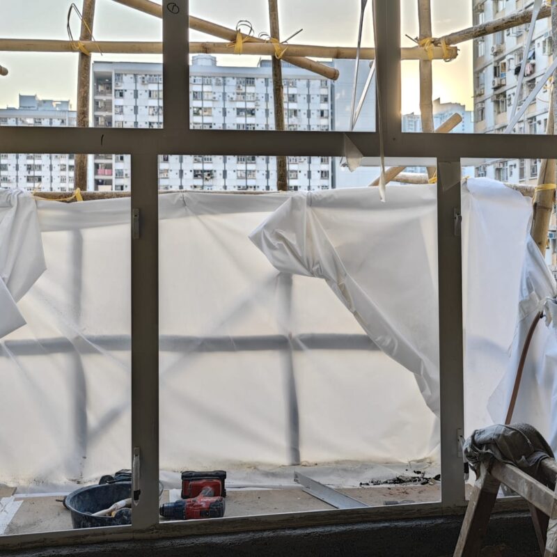 Professional new aluminium window frame installation with safety scaffolding, fully compliant with Buildings Department standards.