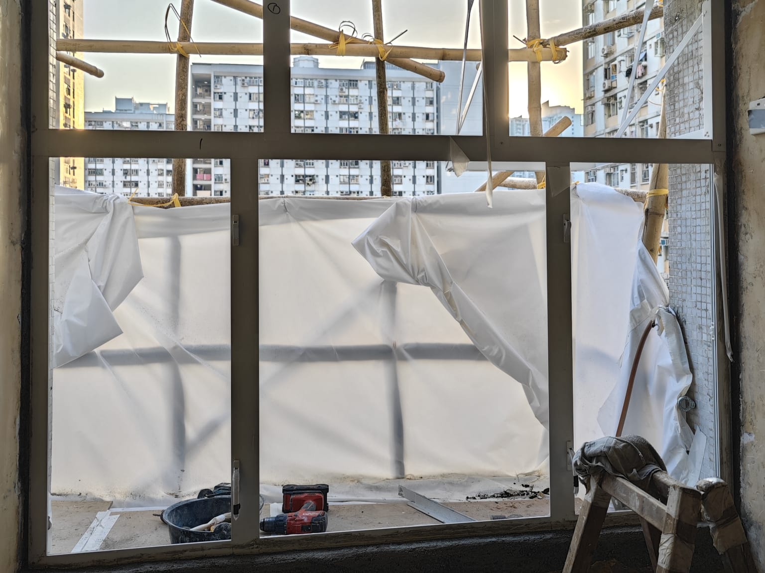 Professional new aluminium window frame installation with safety scaffolding, fully compliant with Buildings Department standards.
